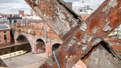 View through steel cross beams from Castlefield Viaduct, Manchester.